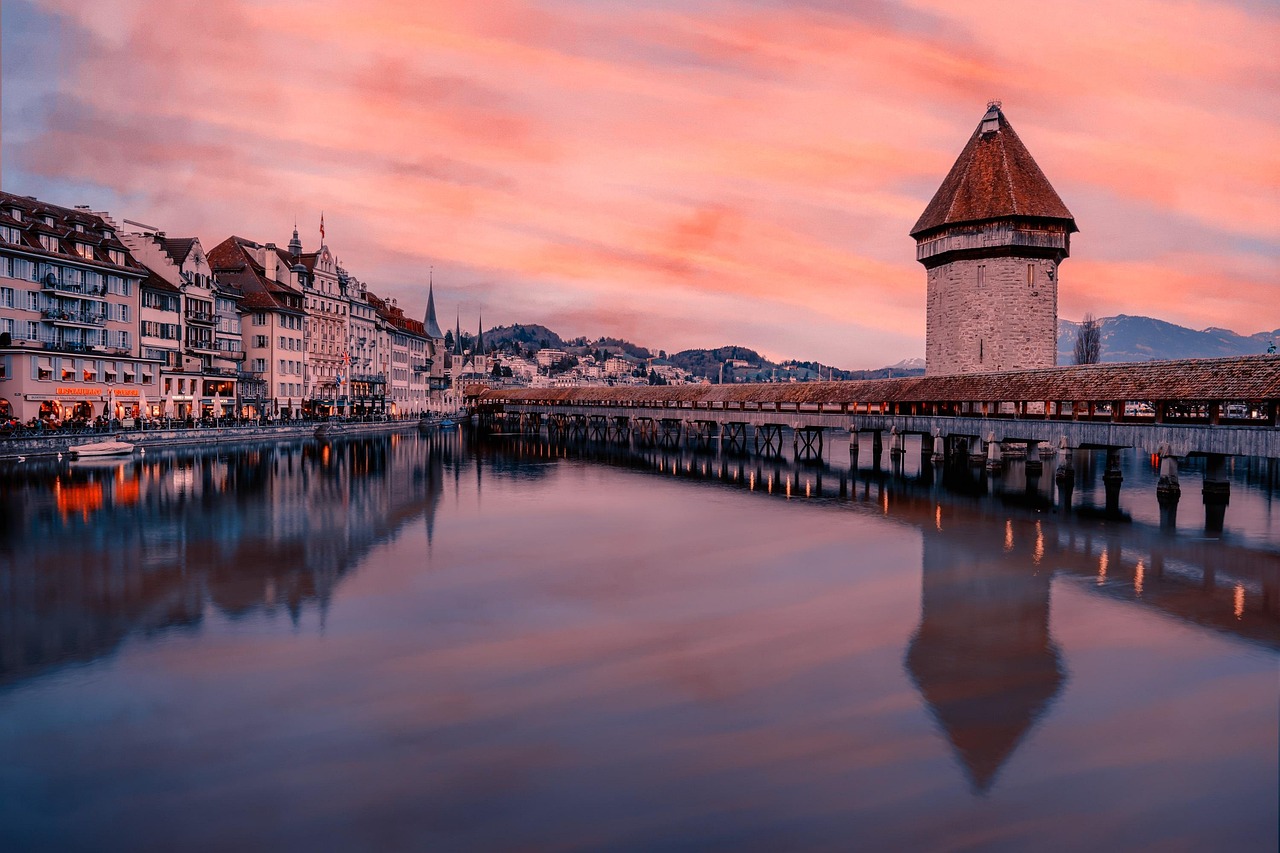 Lucerne Chapel Bridge and Water Tower on the Reuss river with the Alps behind